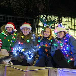 Group of students with Christmas lights and santa hats