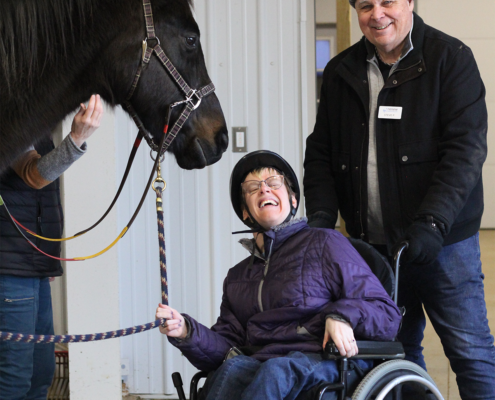 Student and volunteer posing with Zen after a lesson.