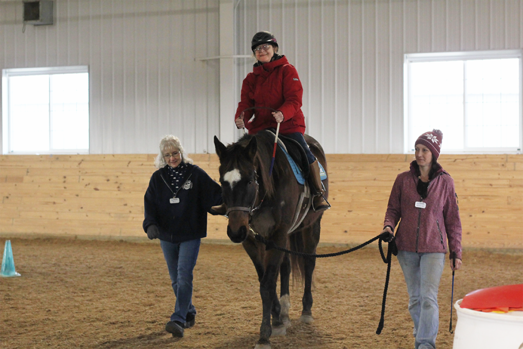 Student riding Fresco during a therapeutic riding lesson.