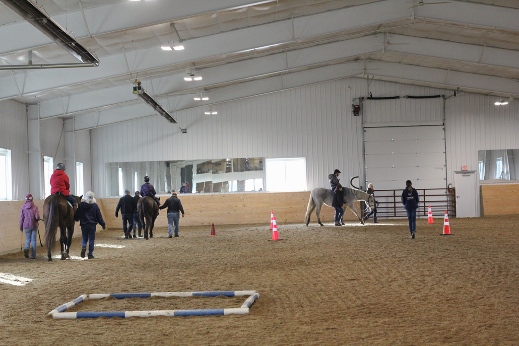 Therapeutic riding lesson in the indoor arena.