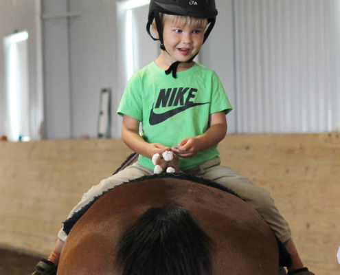 Speech camper riding backwards during a lesson.