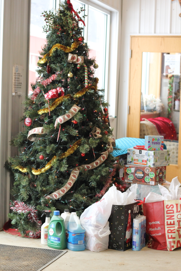 Giving Tree stocked with presents in the arena.