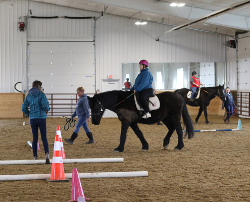 students riding in a lesson