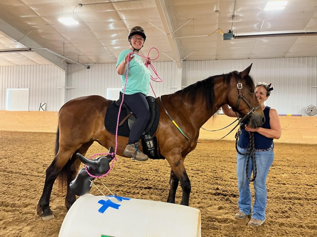 Student lassos fake steer during a western themed lesson.