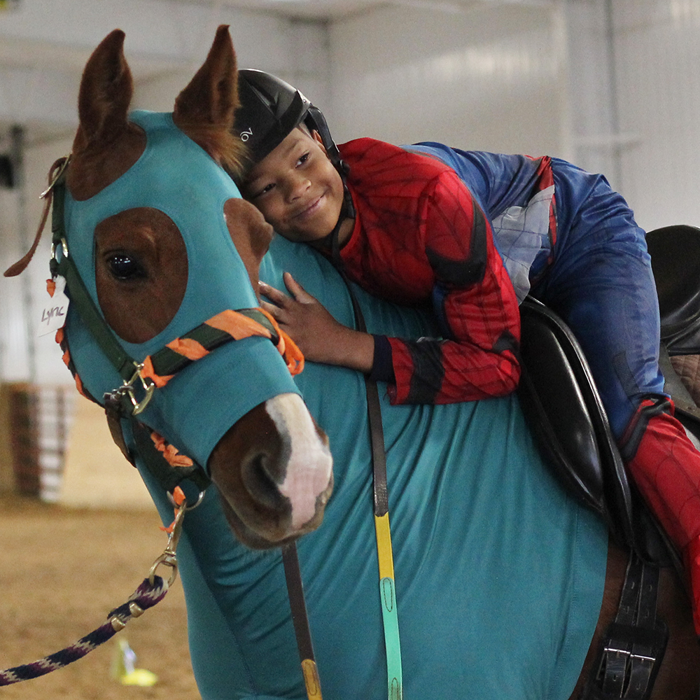 Student posing with horse at Shodeo.