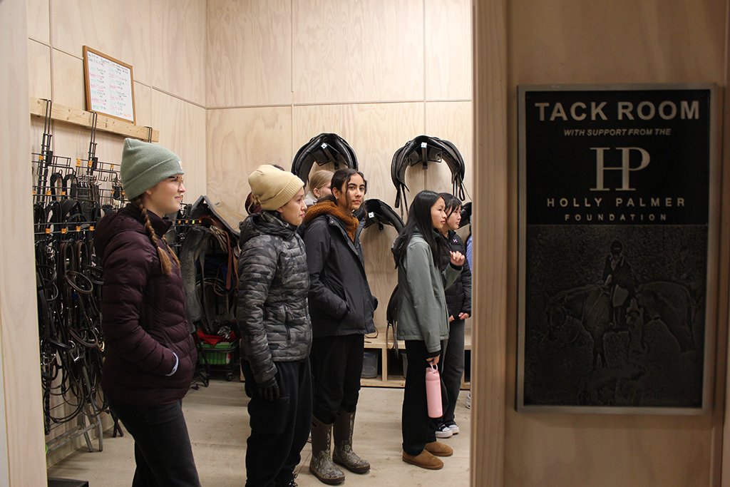 Youth Advisory Committee students tour Renew's tack room and learn about different types of adaptive tack.