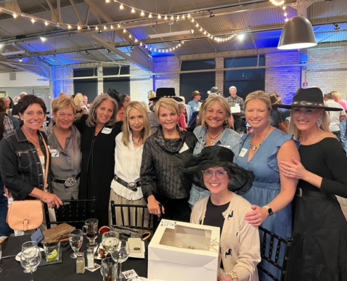Group of Denim & Diamonds at the Derby guests pose for a picture.